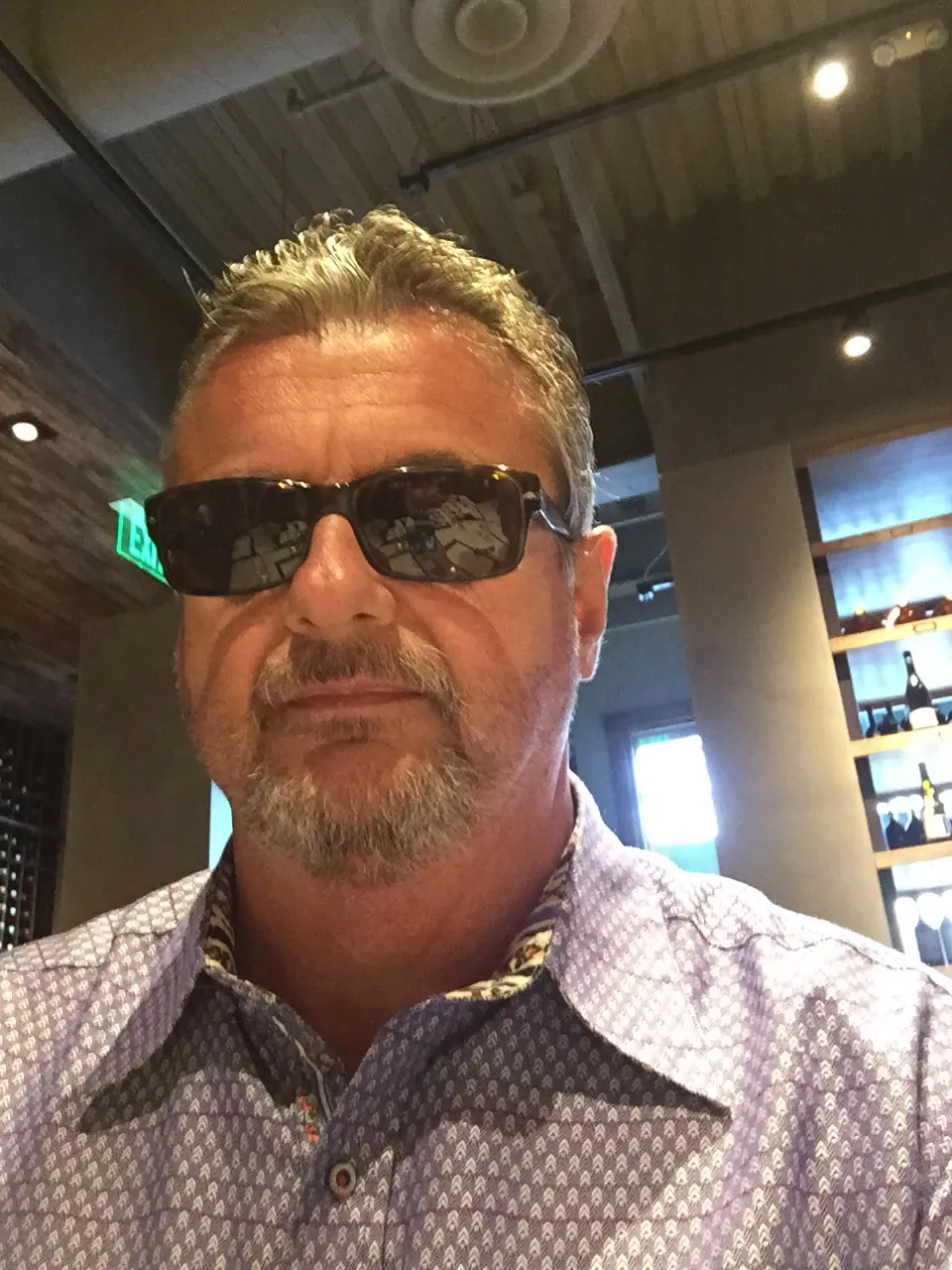 Jeff C. West wearing sunglasses and a patterned shirt